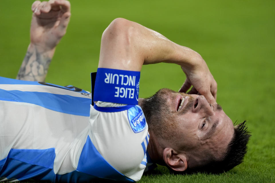 Argentina's Lionel Messi grimaces in pain during the Copa America final soccer match against Colombia in Miami Gardens, Fla., Sunday, July 14, 2024. (AP Photo/Rebecca Blackwell)