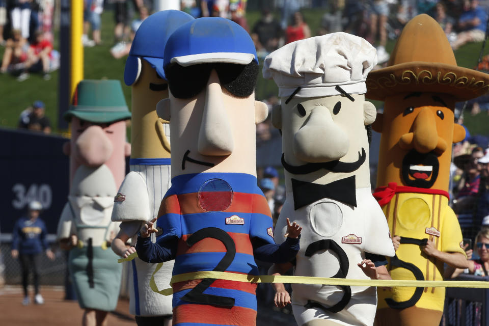 Polish Sausage (2) wins the sausage race between innings of a spring training baseball game between the Los Angeles Angels and the Milwaukee Brewers, Sunday, March 8, 2020, in Phoenix, Ariz. (AP Photo/Sue Ogrocki)