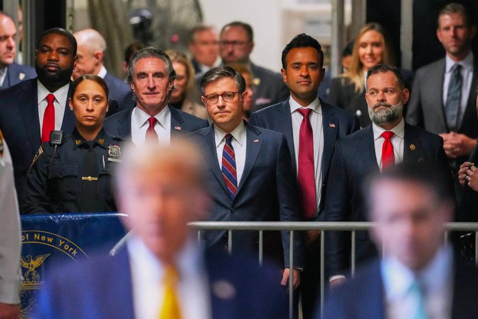 PHOTO: Doug Burgum, Speaker of the House Mike Johnson and Vivek Ramaswamy look on as former President Donald Trump talks to the media outside Manhattan criminal court in New York, May 14, 2024. (Curtis Means/POOL/AFP via Getty Images)