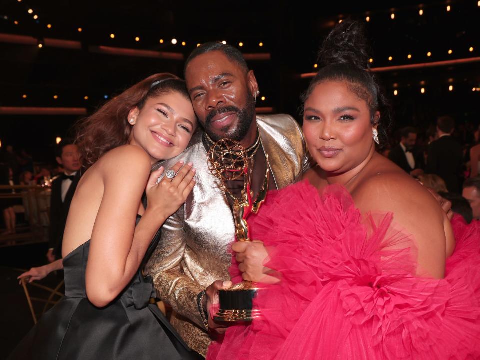 zendaya leaning into colman domingo's shoulder and smiling. domingo has a joyous expression on his face, and lizzo also leans with them, smiling