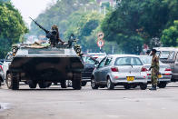 <p>An armoured personnel carrier stations by an intersection as Zimbabwean soldiers regulate traffic in Harare on Nov. 15, 2017. (Photo: AFP/Getty Images) </p>