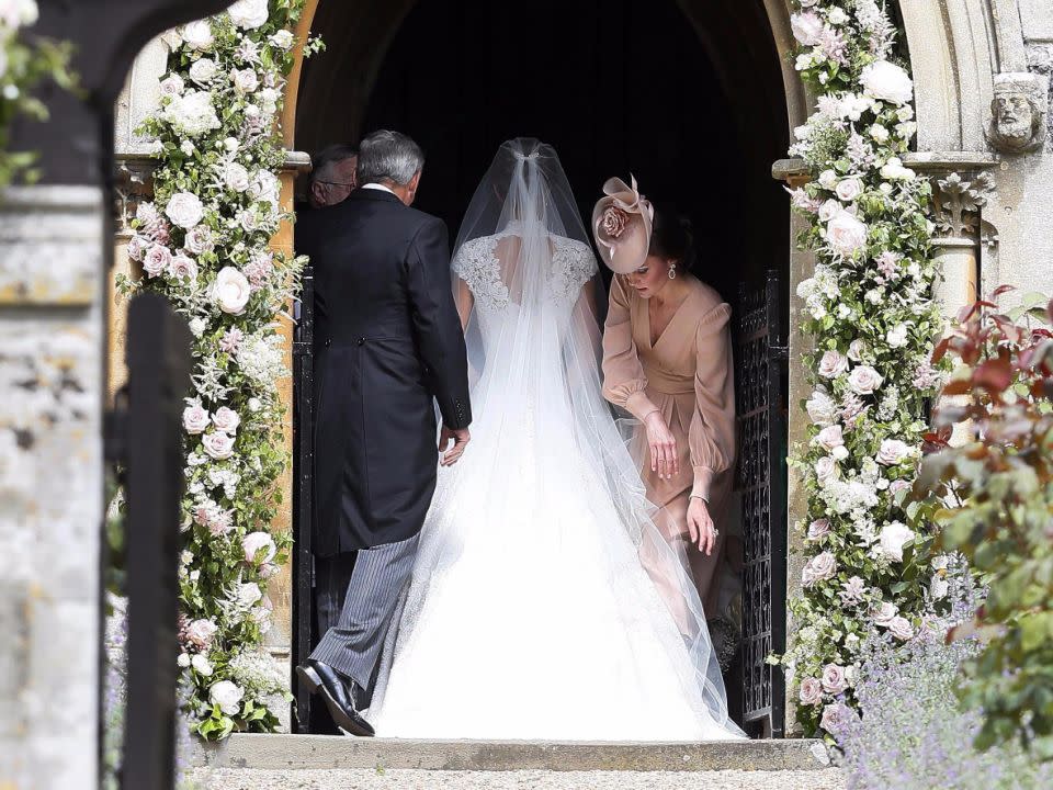 Even Pippa caught some of Kate's motherly ways when her veil needed straightening. Source: Getty