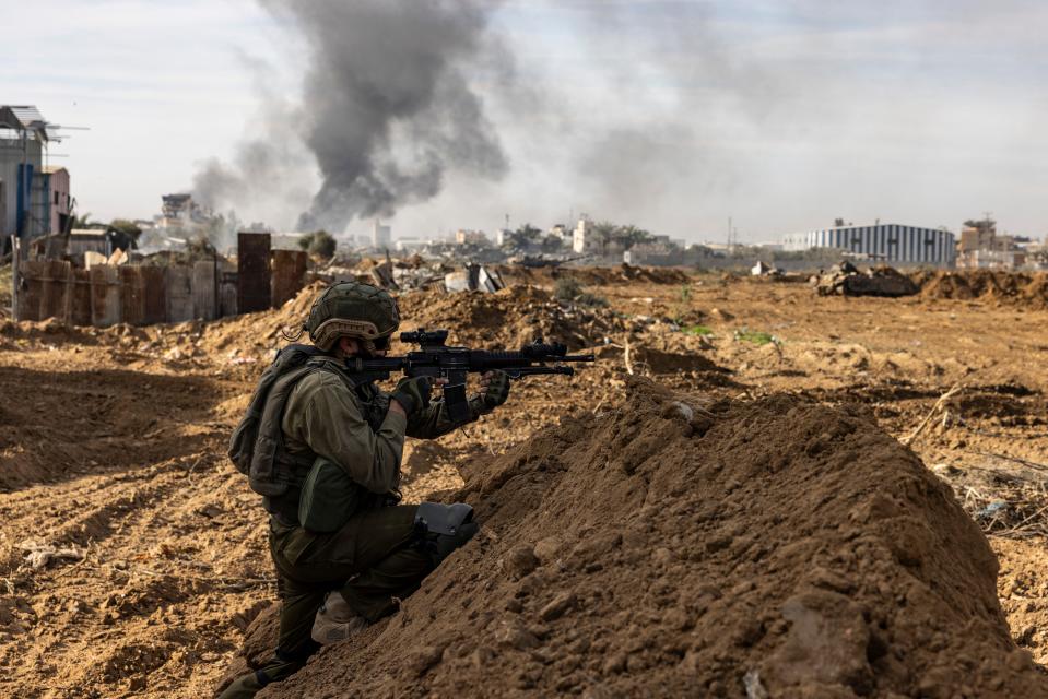 This picture taken during a media tour organized by the Israeli military on January 8, 2024, shows troops operating in the area of al-Bureij in the central Gaza Strip.