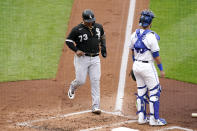 Chicago White Sox's Yermin Mercedes runs home to score past Kansas City Royals catcher Sebastian Rivero on a double by Andrew Vaughn during the first inning of a baseball game Saturday, May 8, 2021, in Kansas City, Mo. (AP Photo/Charlie Riedel)