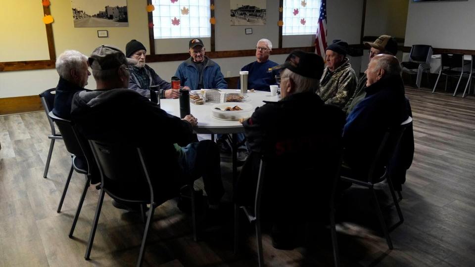 Earl Meyer, middle left, who fought for the U.S. Army in the Korean War, talks with fellow veterans at the American Legion, Tuesday, Nov. 7, 2023, in St. Peter, Minn. (Abbie Parr/AP)