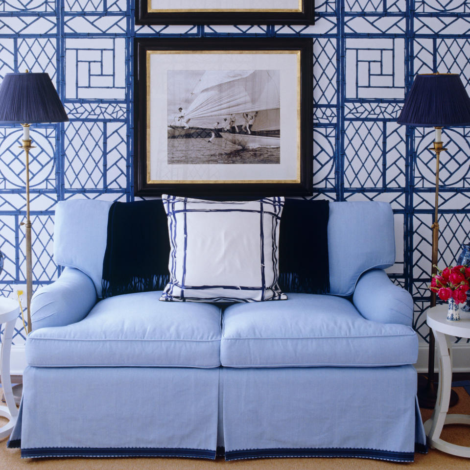 <p>Patterns won't make you dizzy if you partner them with simple, refined pieces like the solid-colored sofa and sleek lamps. Hanging a black-and-white photo or two also brings visual relief to the busyness of a lattice-papered wall. </p>