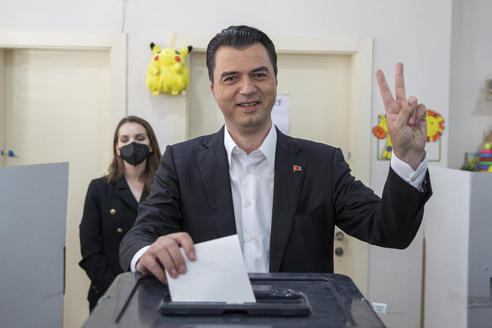 Albanian leader of the opposition Lulzim Basha flashes victory sign as he casts his ballot during parliamentary elections in capital Tirana, Albania on Sunday, April 25, 2021. Albanian voters have started casting ballots in parliamentary elections on Sunday amid the virus pandemic and a bitter political rivalry between the country's two largest political parties. (AP Photo/Visar Kryeziu)