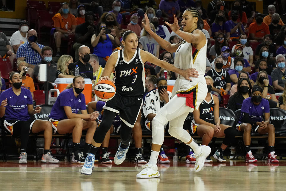 Phoenix Mercury guard Diana Taurasi (3) drives against Las Vegas Aces center Liz Cambage during the first half of a WNBA basketball game Sunday, Oct. 3, 2021, in Phoenix. (AP Photo/Rick Scuteri)