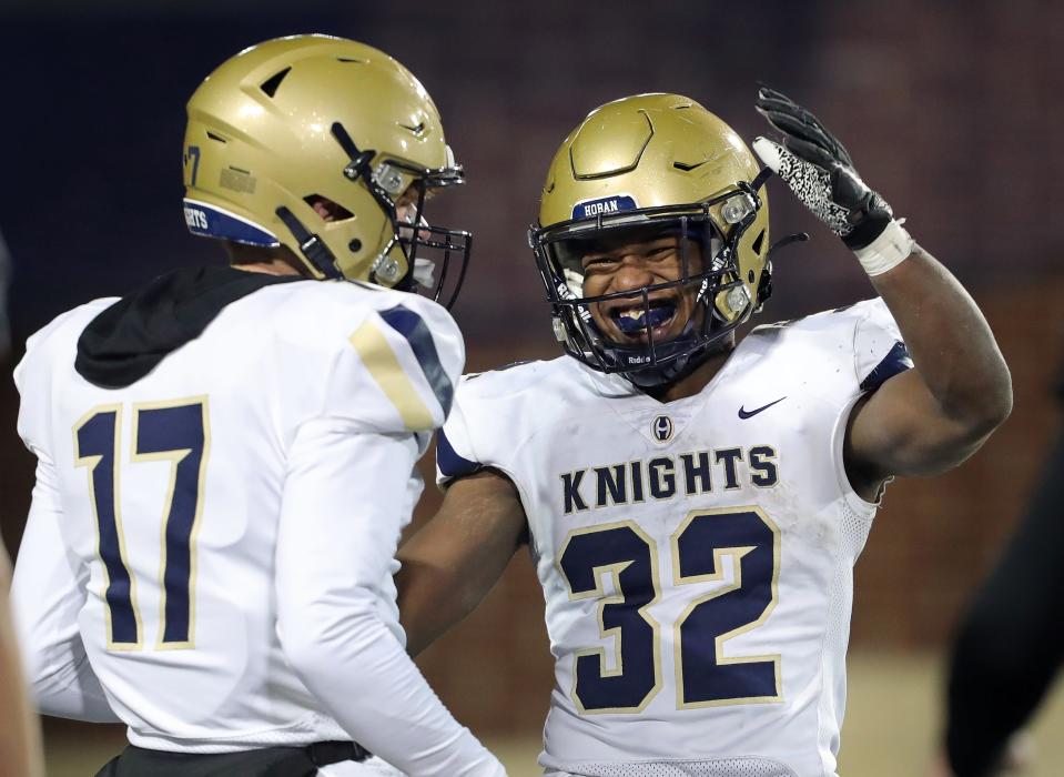 Akron Hoban's Lamar Sperling celebrates a touchdown run with quarterback Michael Ciavolella during a Division II state semifinal win over Massillon last season.