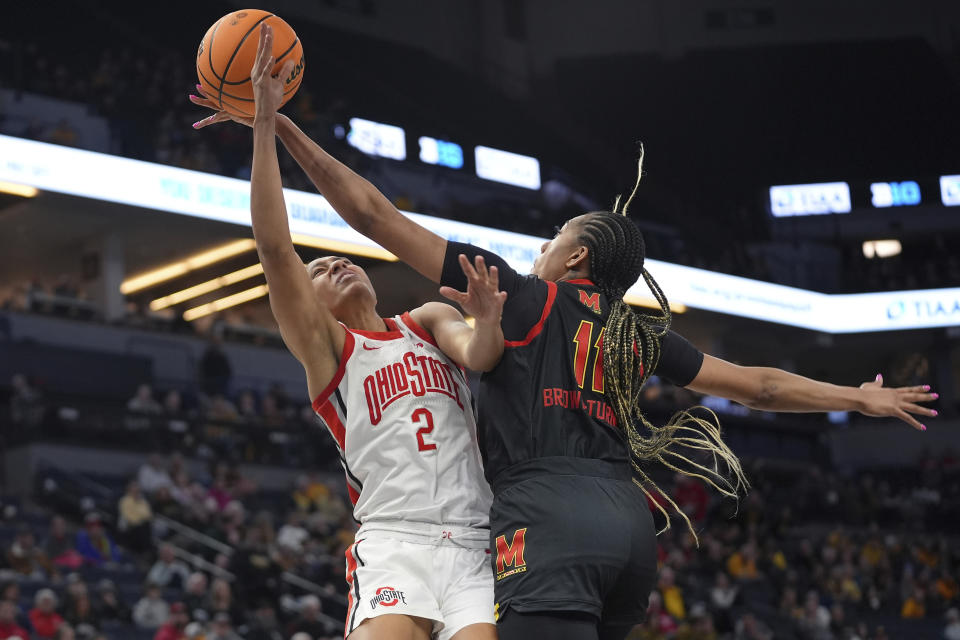 Maryland guard Jakia Brown-Turner (11) blocks a shot attempt by Ohio State guard Taylor Thierry (2) during the second half of an NCAA college basketball game in the quarterfinals of the Big Ten women's tournament Friday, March 8, 2024, in Minneapolis. (AP Photo/Abbie Parr)