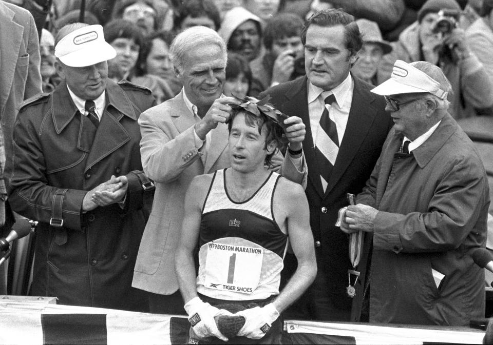 FILE - In this April 16, 1979 file photo, Bill Rodgers of Melrose, Mass., is crowned winner of the Boston Marathon by Mayor Kevin H. White, left, as Massachusetts Gov. Edward J. King, right, observes. A new film that captures much of the Boston Marathon's colorful history premieres Saturday, April 15, 2017, in conjunction with the 121st running of the race on Monday. (AP Photo, File)