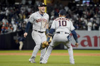 Houston Astros third baseman Alex Bregman (2) and first baseman Yuli Gurriel (10) celebrate after the Astros defeated the New York Yankees 6-5 to win Game 4 and the American League Championship baseball series, Monday, Oct. 24, 2022, in New York. (AP Photo/John Minchillo)