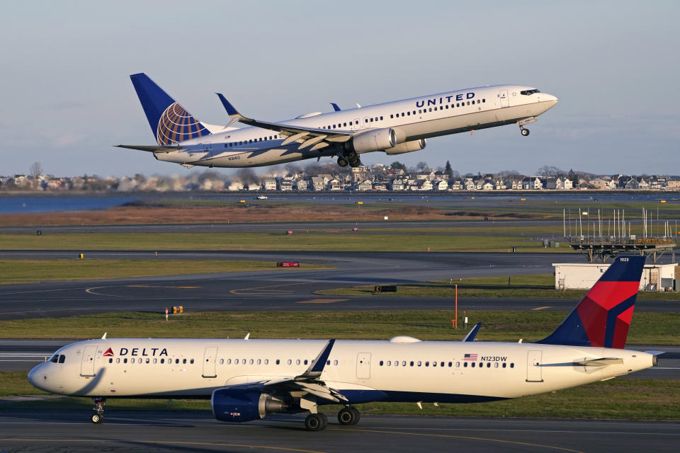 FILE - A United Airlines jet takes off while a Delta Airlines plane taxis at Logan International Airport, Monday, Nov. 21, 2022, in Boston. More than 55 million people are expected to travel at least 50 miles from home for Thanksgiving this year. And while misery loves company, there are some steps travelers can take to improve the experience. (AP Photo/Charles Krupa, File)