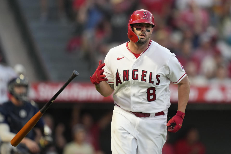 Los Angeles Angels' Mike Moustakas (8) drops his bat after hitting a home run during the third inning of a baseball game against the Seattle Mariners in Anaheim, Calif., Friday, Aug. 4, 2023. Shohei Ohtani and C.J. Cron also scored. (AP Photo/Ashley Landis)