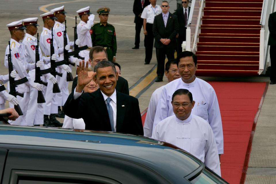 YANGON, MYANMAR - NOVEMBER 19: US President Barack Obama alongside Secretary of State Hilary Clinton (L) chat with Burmese Foreign minister Wunna Maung Lwin (R) as they arrive at Yangon International airport during a historical visit to the country on November 19, 2012 in Yangon, Myanmar. Obama is the first US President to visit Myanmar while on a four-day tour of Southeast Asia that also includes Thailand and Cambodia. (Photo by Paula Bronstein/Getty Images)