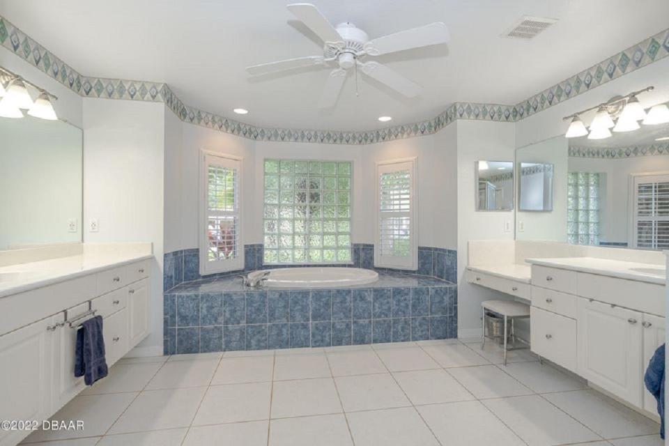 The primary suite includes this spacious bathroom with double vanities and a huge soaking tub.