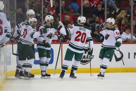 Feb 9, 2019; Newark, NJ, USA; Minnesota Wild left wing Zach Parise (11) celebrates with teammates after scoring a goal during the second period against the New Jersey Devils at Prudential Center. Mandatory Credit: Ed Mulholland-USA TODAY Sports
