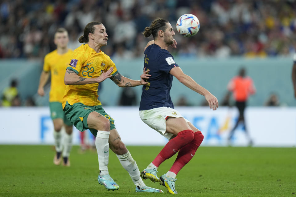 Australia's Jackson Irvine, left, challenges for the ball with France's Adrien Rabiot during the World Cup group D soccer match between France and Australia, at the Al Janoub Stadium in Al Wakrah, Qatar, Tuesday, Nov. 22, 2022. (AP Photo/Francisco Seco)