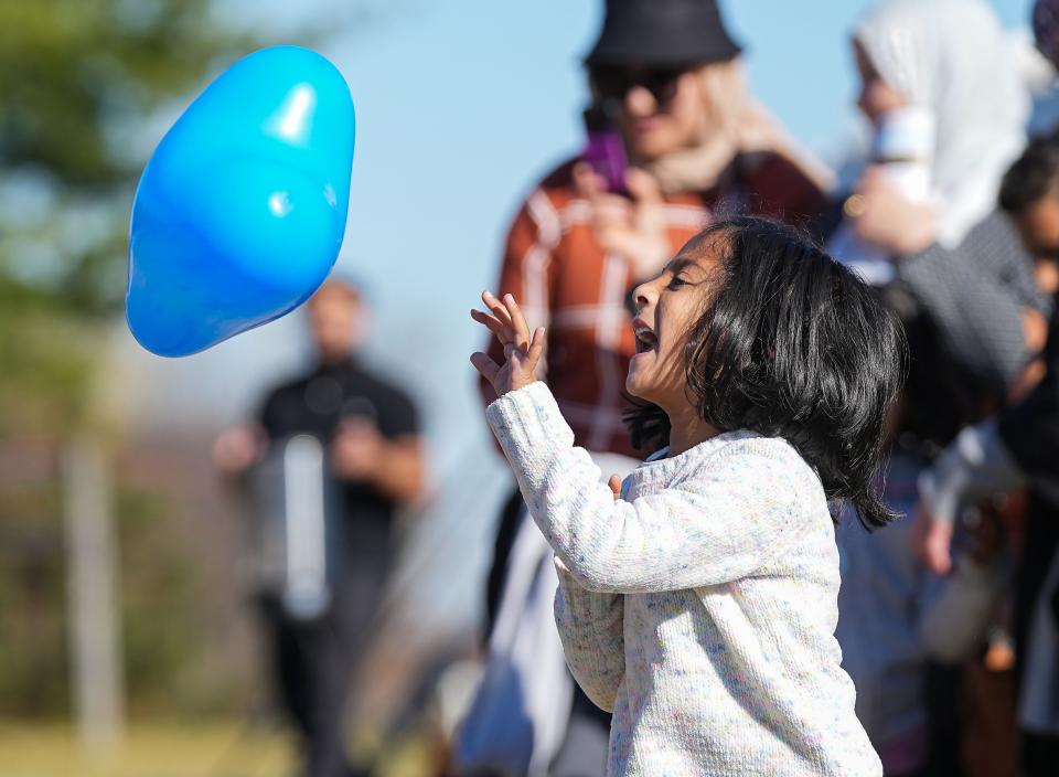 Rania Khan, 4, plays with a balloon during a gathering at a ground breaking ceremony for the Islamic Life Center apart of the Al Salam Foundation on Saturday, Oct. 29, 2022, on Shelborne Road in Carmel. 