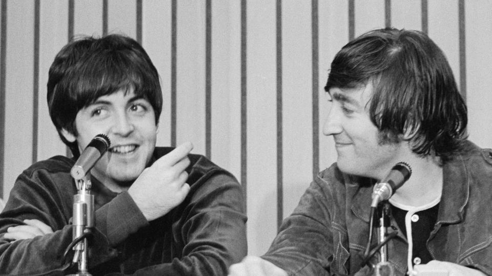 Portland, Ore.: John Lennon (right) smiles as Paul McCartney speaks at press conference held after Beatles performance in Portland.