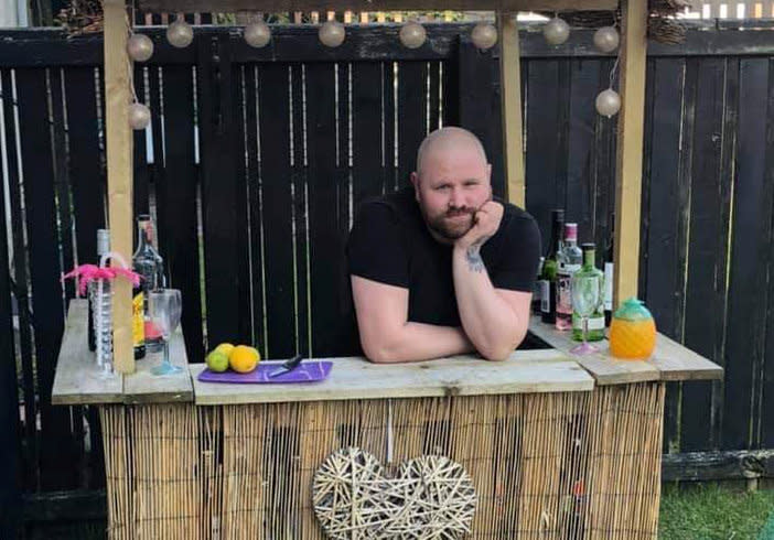 A man built a Tiki bar in his garden to help him survive the boredom of lockdown. (SWNS)