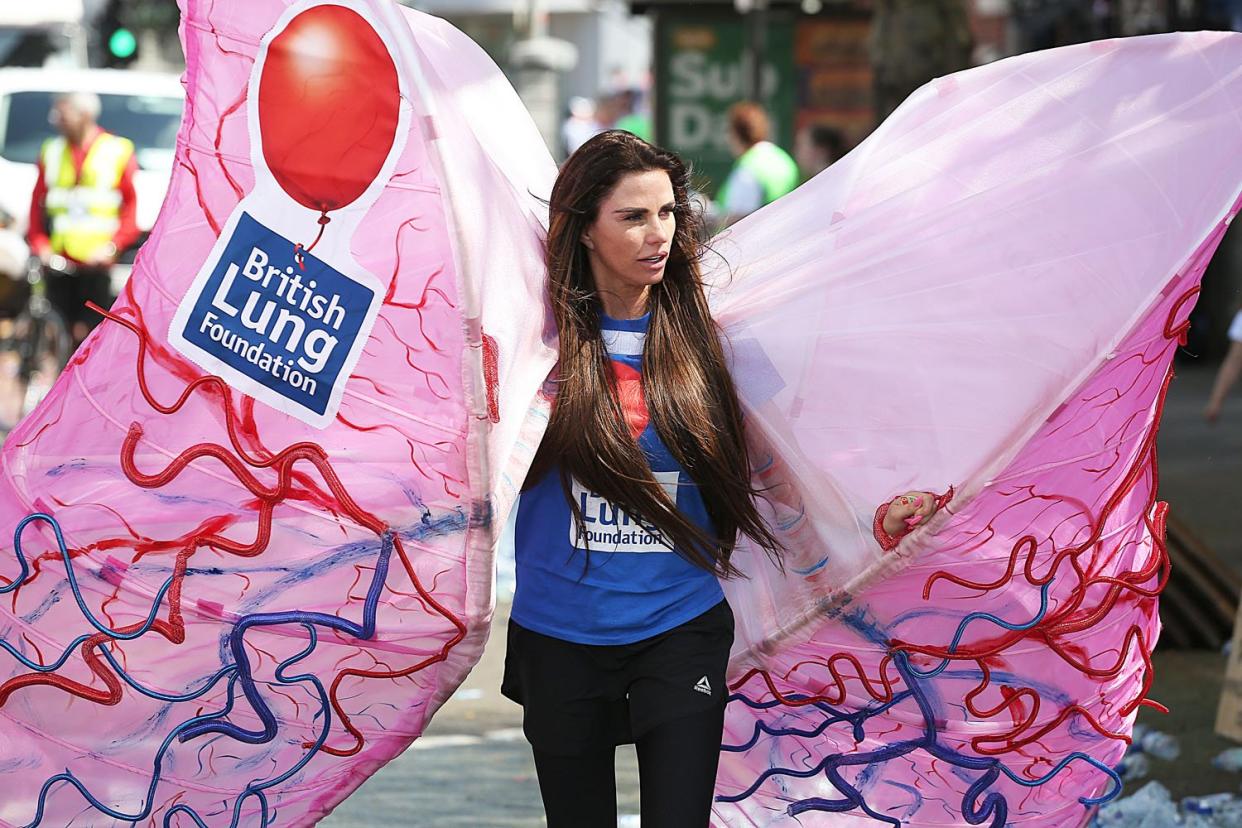 Struggling: Katie Price wearing a pair of lungs: Splash News