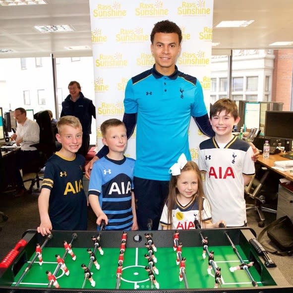 Dele Alli poses for photos in a charity event