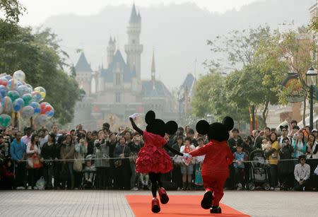 Mickey Mouse and Minnie Mouse characters greet visitors with their latest Year of the Mouse costumes at Hong Kong Disneyland, China in January 21, 2008. REUTERS/Bobby Yip/File Photo