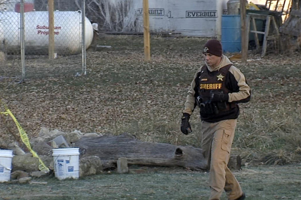 In this image taken from video, a sheriff's official walks near the location where Valerie Tindall's remains were discovered Wednesday, Nov. 29, 2023, in Arlington, Ind. A coroner has identified the remains of the 17-year-old Tindall, who vanished in June and whose body was found in a box buried on land owned by a man now charged in her death. (WRTV via AP)