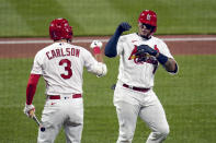 St. Louis Cardinals' Yadier Molina, right, is congratulated by teammate Dylan Carlson (3) after hitting a solo home run during the sixth inning of a baseball game against the Washington Nationals Monday, April 12, 2021, in St. Louis. (AP Photo/Jeff Roberson)