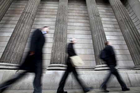 Pedestrians walk past the columns of the Bank of England, in the City of London in this February 15, 2011 file photo. REUTERS/Andrew Winning/Files