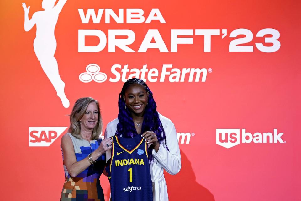 Aliyah Boston (right) and WNBA Commissioner Cathy Engelbert pose with an Indiana Fever jersey.