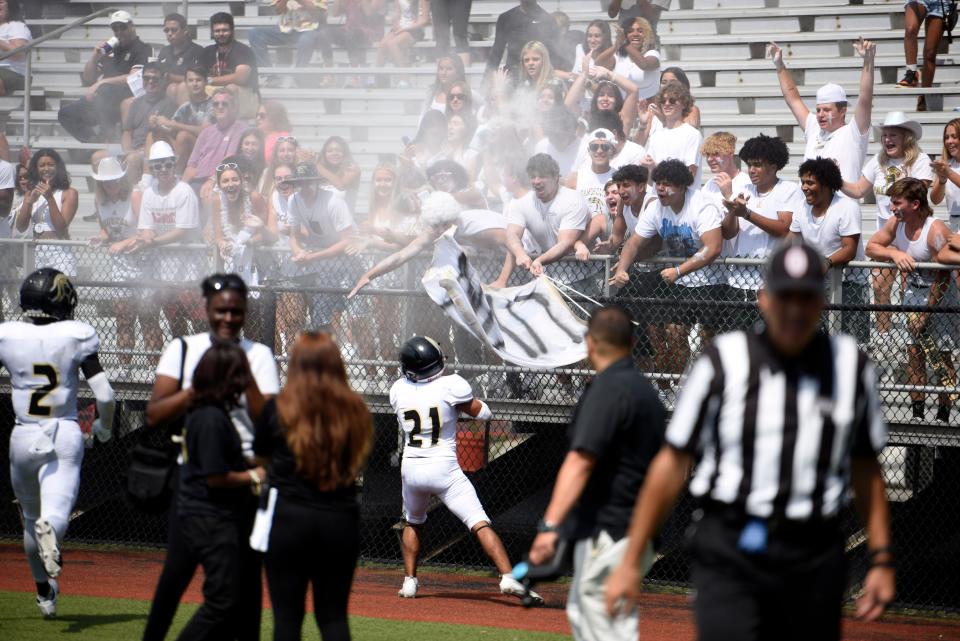 Paramus Catholic Football at Hudson Catholic on Saturday, Sept. 3, 2022. PC #21 Jayden Beauchamp celebrates with fans after scoring a touchdown in the second quarter. 