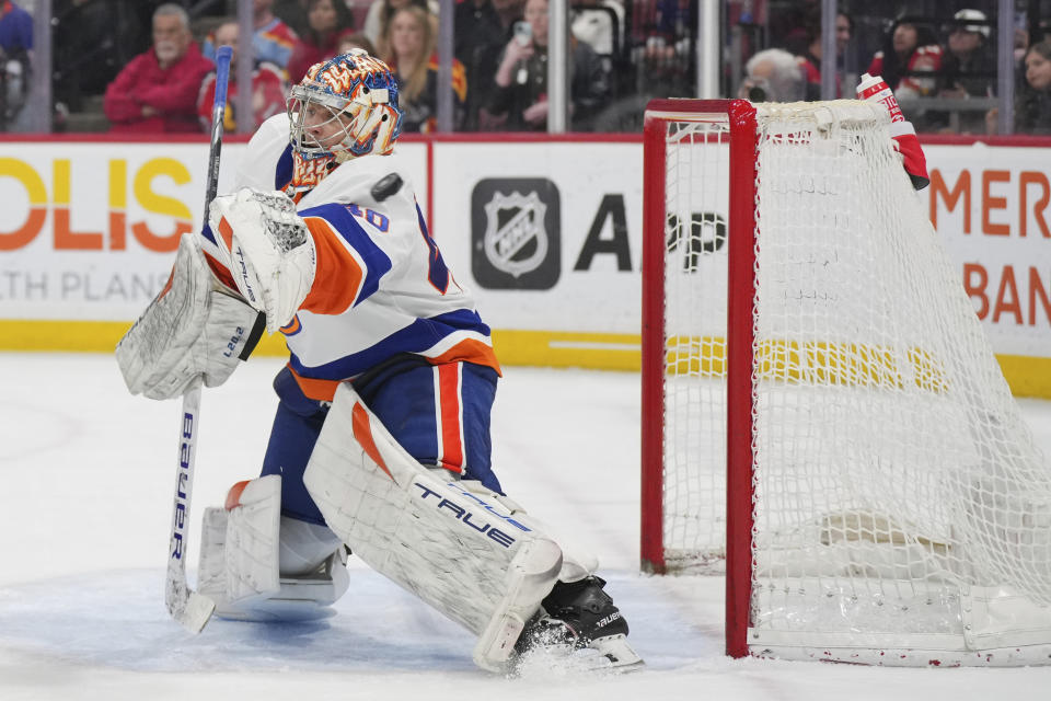 New York Islanders goaltender Semyon Varlamov reaches for the puck as it sails wide during the second period of the team's NHL hockey game against the Florida Panthers on Thursday, March 28, 2024, in Sunrise, Fla. (AP Photo/Jim Rassol)