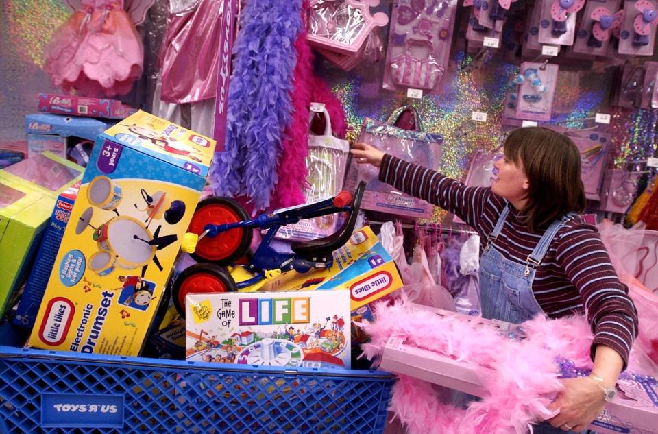 Paula Byrd, of Dunn, N.C., browses through the dress-up clothes at Toys "R" Us Friday morning, Nov. 25, 2005, as she stays close to her over-flowing shopping cart of gifts for her three children.