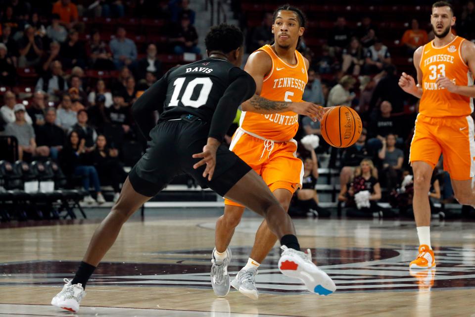 Tennessee guard Zakai Zeigler (5) dribbles as Mississippi State guard Dashawn Davis (10) defends during the first half at Humphrey Coliseum.