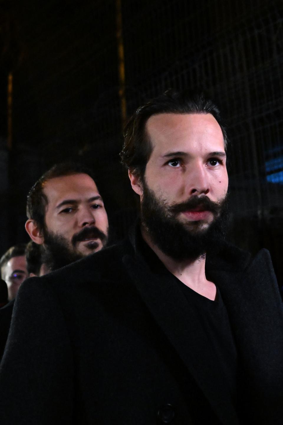 British-US former professional kickboxer and controversial influencer Andrew Tate (L) and his brother Tristan Tate walk out of the central arrest centre of Bucharest police after three months of pre-trial detention, in Bucharest, on late March 31, 2023. - A Romanian court on March 31, 2023 ordered that controversial influencer Andrew Tate and his brother be moved from jail to house arrest while they are investigated for alleged human trafficking and rape. (Photo by Daniel MIHAILESCU / AFP) (Photo by DANIEL MIHAILESCU/AFP via Getty Images)