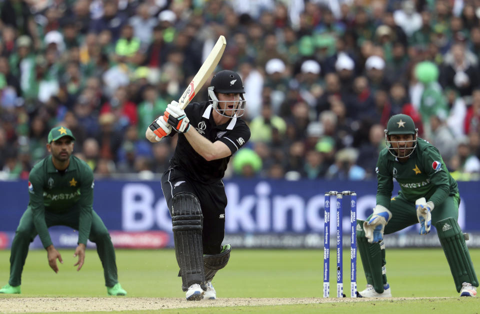 New Zealand's batsman James Neesham, middle, reacts after playing a shot as Pakistan's captain Sarfaraz Ahmed, right and teammate watches on during the Cricket World Cup match between New Zealand and Pakistan at the Edgbaston Stadium in Birmingham, England, Wednesday, June 26, 2019. (AP Photo/Rui Vieira)