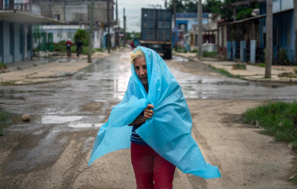 A woman in Cuba wrapped in blue plastic sheet.