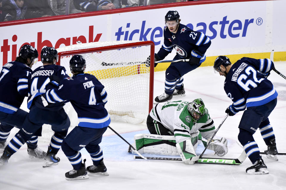 Dallas Stars' goaltender Scott Wedgewood (41) makes a save against Winnipeg Jets' Nino Niederreiter (62) during the third period of an NHL hockey match in Winnipeg, Manitoba, on Saturday, Nov. 11, 2023. (Fred Greenslade/The Canadian Press via AP)