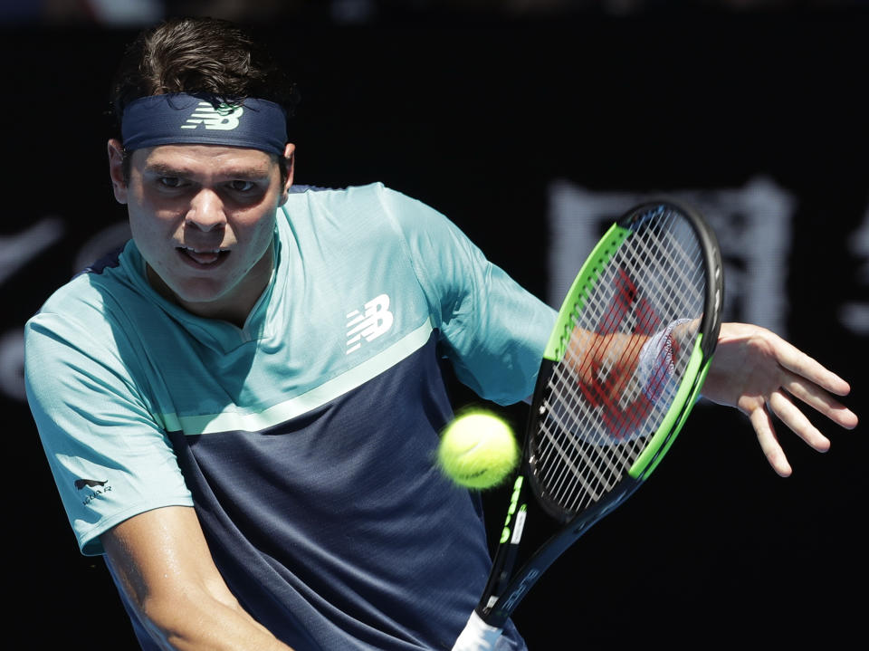 Canada's Milos Raonic makes a backhand return to Germany's Alexander Zverev during their fourth round match at the Australian Open tennis championships in Melbourne, Australia, Monday, Jan. 21, 2019. (AP Photo/Aaron Favila)