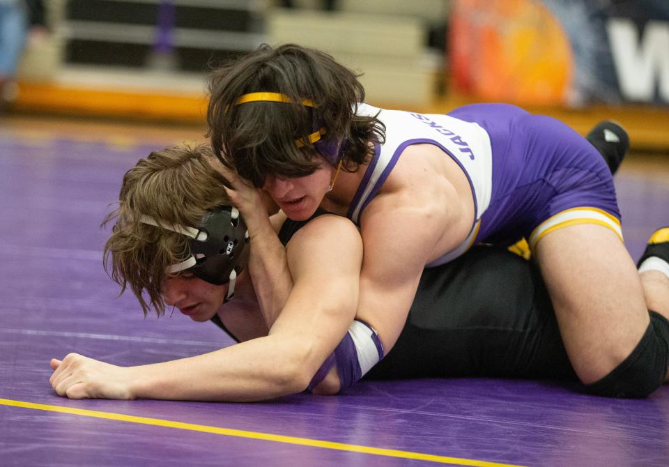Nolan Foster of Jackson and Connor Shephard of Perry wrestle in the 165-pound match Wednesday at Jackson.