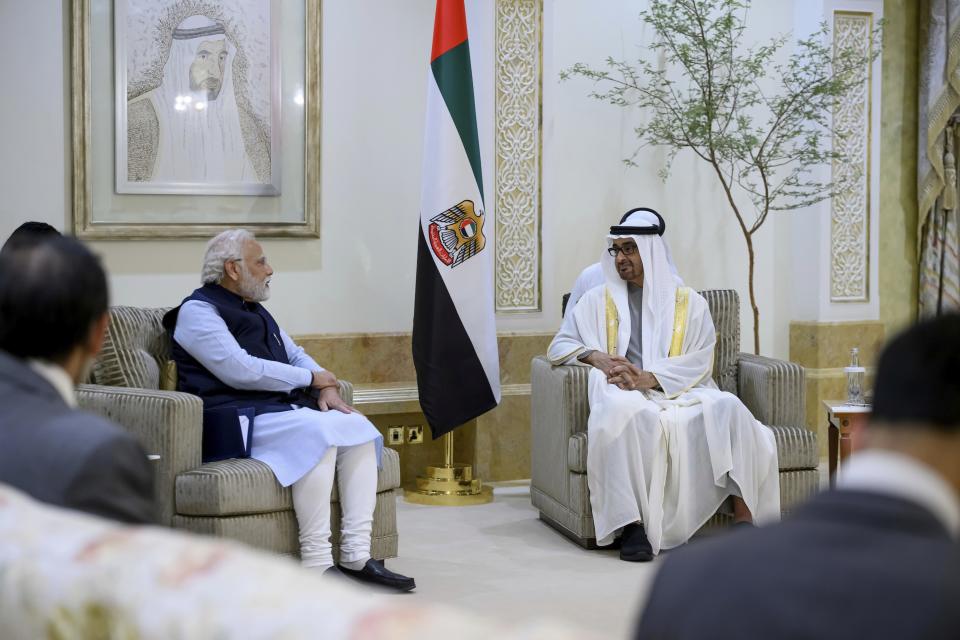 In this photo made available by Ministry of Presidential Affairs, President of the United Arab Emirates Sheikh Mohamed bin Zayed Al Nahyan, right, receives the Prime Minister of India Narendra Modi at the Presidential Airport, in Abu Dhabi, United Arab Emirates, Tuesday, June 28, 2022. (Hamad Al Kaabi/Ministry of Presidential Affairs via AP)