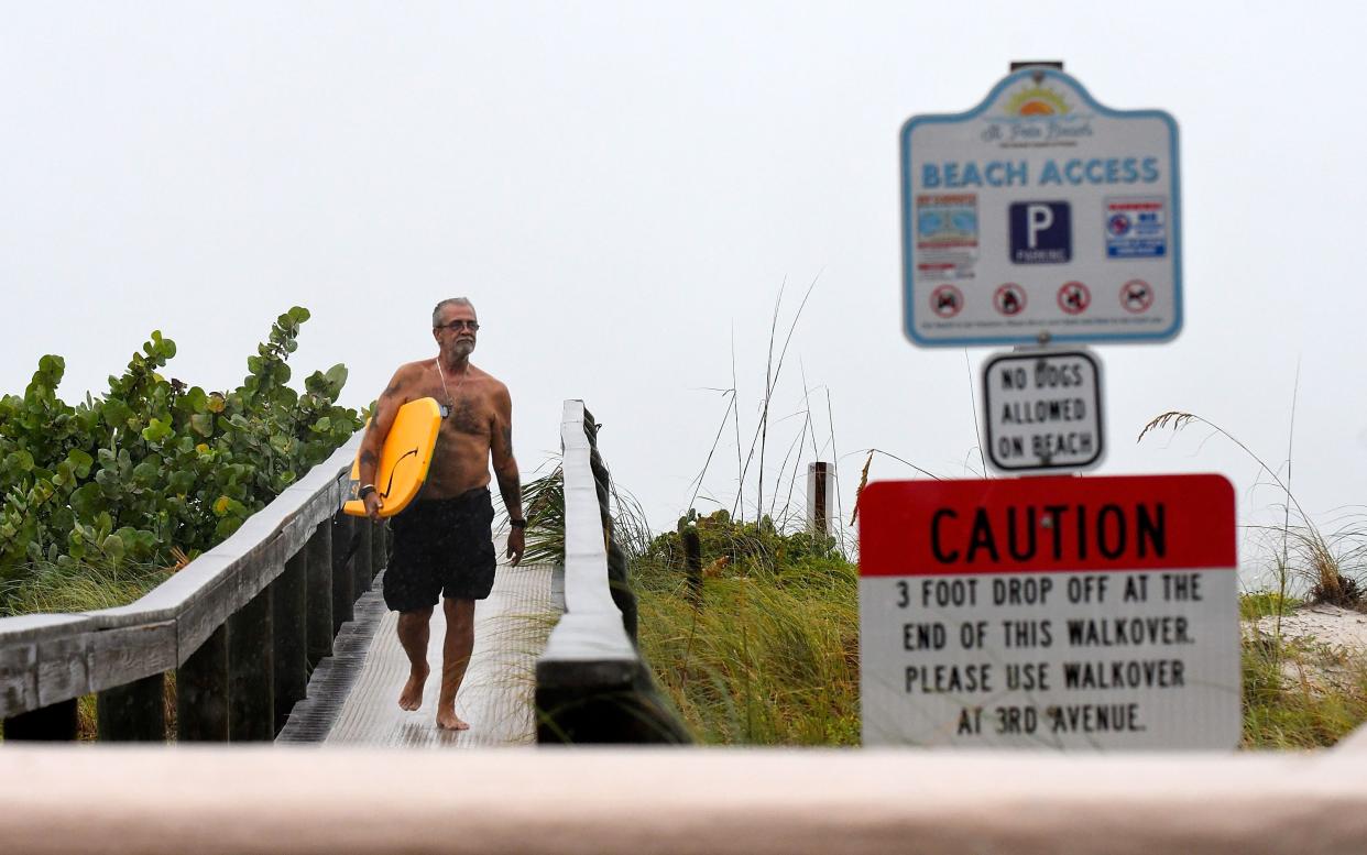 Local resident Mark Seger walks at the bay of St. Pete Beach as the winds from Hurricane Ian arrive on September 28, 2022 in St. Petersburg, Florida. Ian is hitting the area as a Category 4 hurricane.