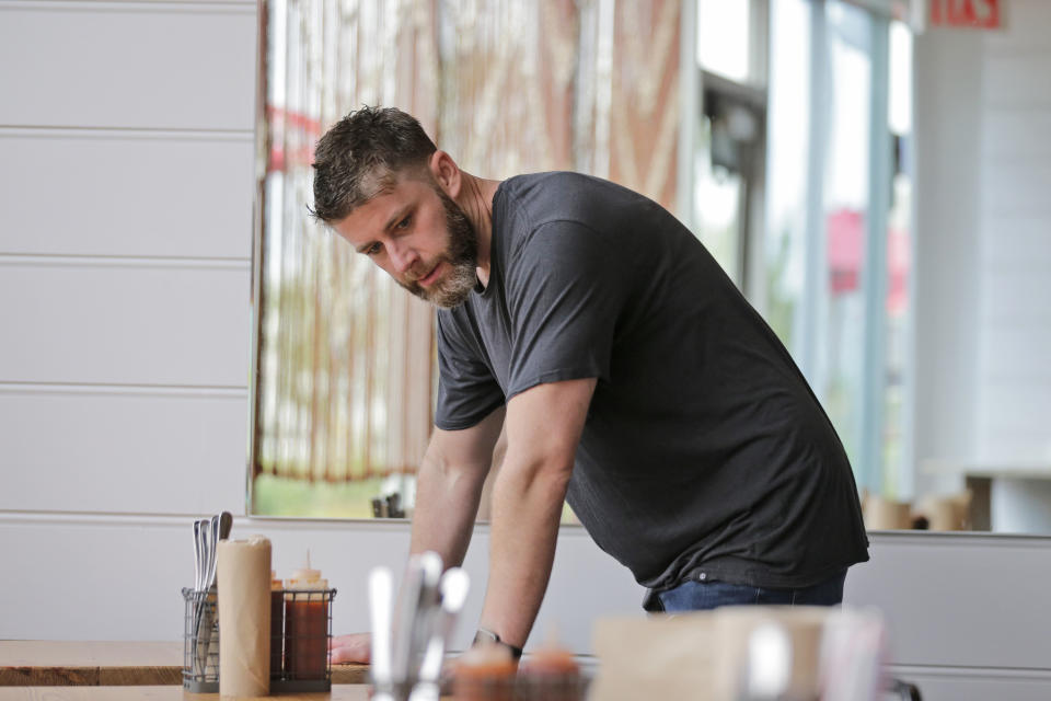 In this Sept. 12, 2019 photo, Chris Miles helps to prepare his restaurant, Batesy's, for opening in the Rockaway section of New York. Miles and his partners were ready to open their new, seaside barbecue joint just in time for the summer season when they got stunning news: There would be no gas to fuel the fryers, griddles and stoves. National Grid has imposed a moratorium on new gas hookups in parts of New York City, saying it can’t meet rising demand without the new pipeline. (AP Photo/Seth Wenig)