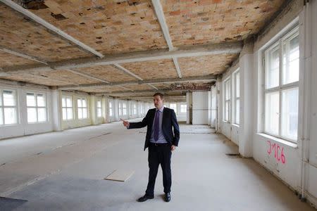 George Darbishire of Ziegert Property stands in a floor of the Metropolis Park development that will be turned into a loft in Berlin June 26, 2014. REUTERS/Thomas Peter