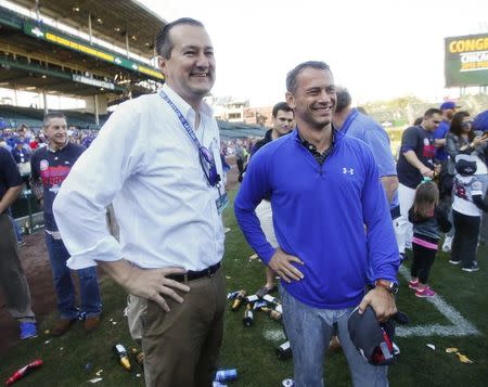 Chicago Cubs owner Tom Ricketts (L) and executive vice-president and general manager Jed Hoyer (R) smile during a celebration after their team clinched wild card playoff berth at Wrigley Field, in Chicago, Illnois, U.S., September 26, 2015. Mandatory Credit: Kamil Krzaczynski-USA TODAY Sports/File Photo