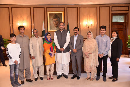 Nobel Peace Prize laureate Malala Yousafzai (4th-L) and her family members pose for a group photo with Pakistan's Prime Minister Shahid Khaqan Abbasi, in Islamabad, Pakistan March 29, 2018. PRESS INFORMATION DEPARTMENT (PID) via REUTERS