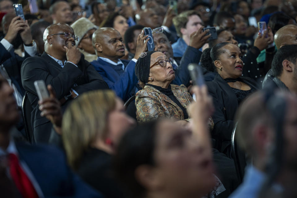 Attendants follow the announcement of the results in South Africa's general elections in Johannesburg, South Africa on Sunday, June 2, 2024. Humbled by a stinging election result, South Africa's African National Congress was talking to everyone in an effort to form a stable coalition government for Africa's most advanced economy after it lost its 30-year majority. (AP Photo/Emilio Morenatti)