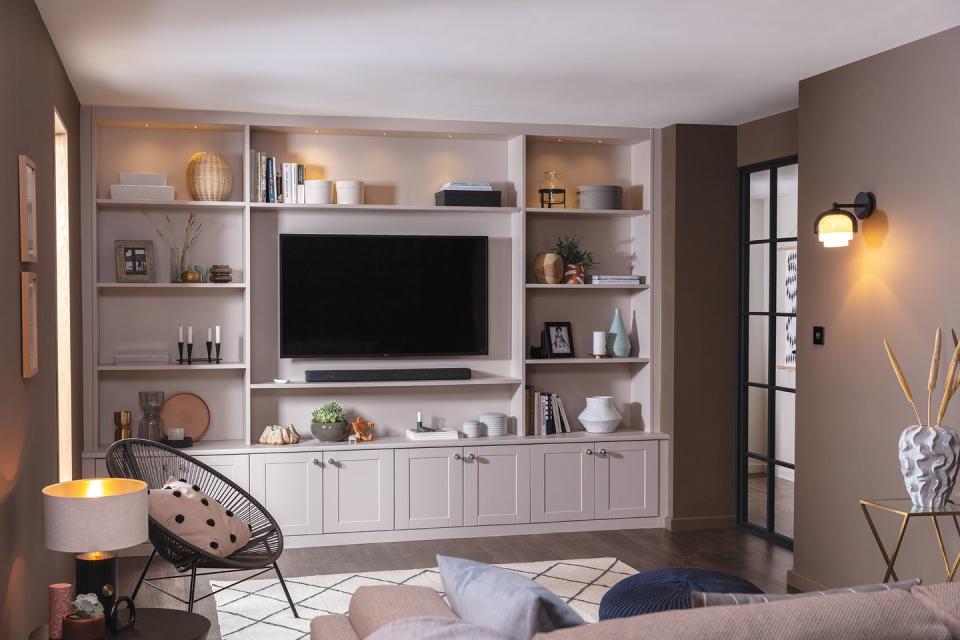 a room with a tv and shelves